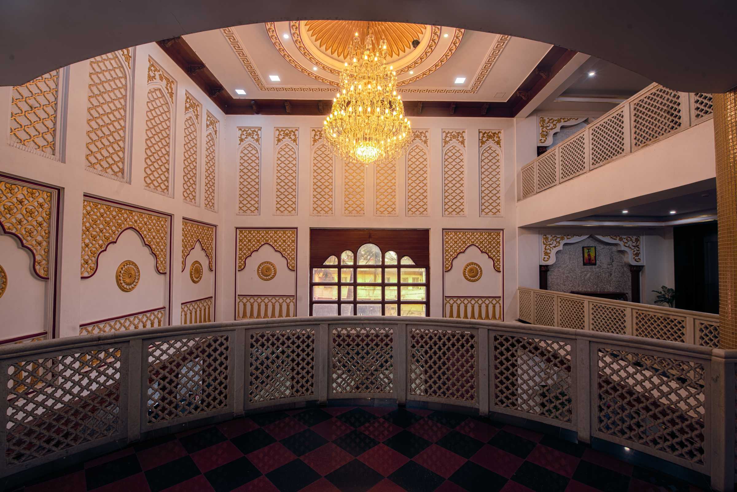 Upper floor gold lattice panels and crystal chandelier