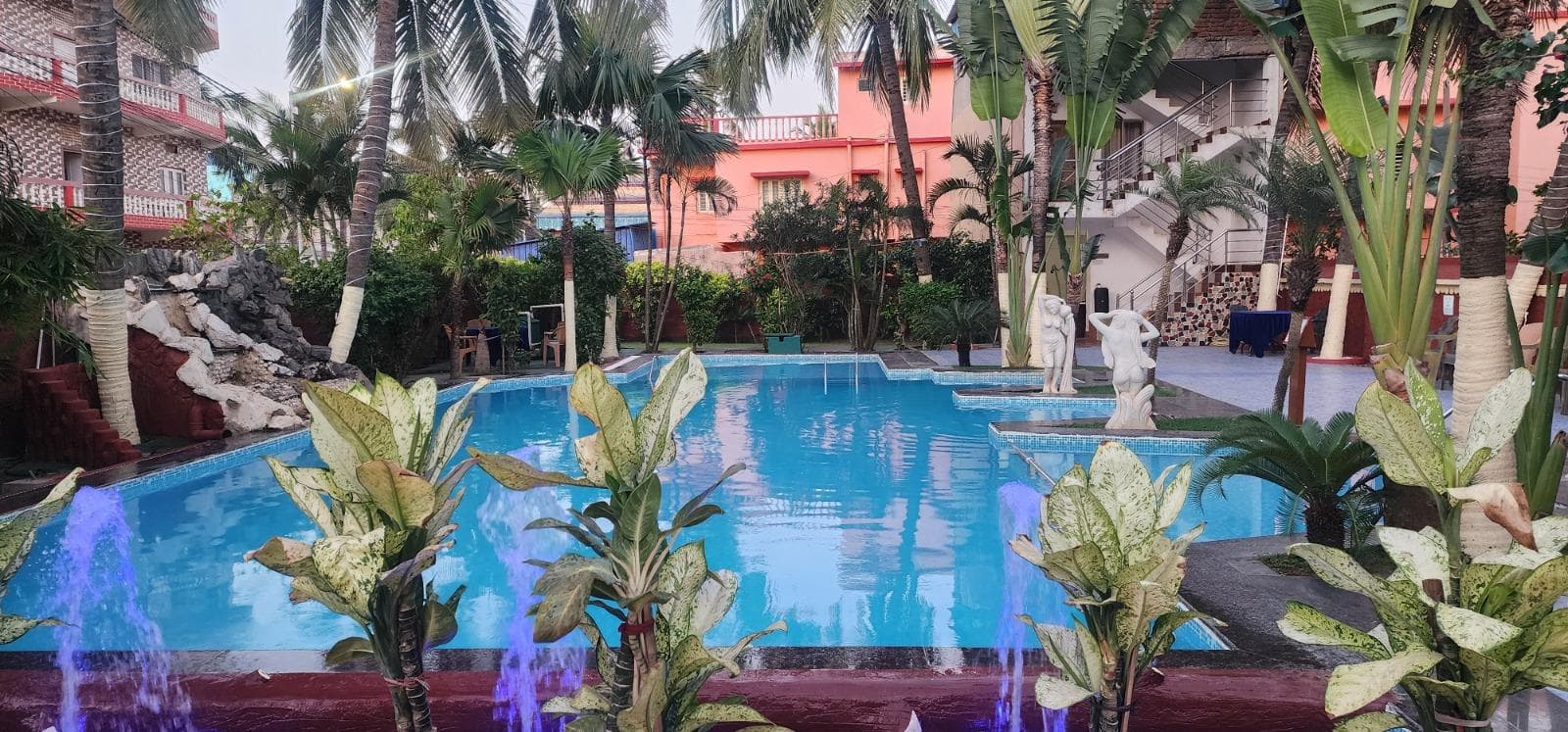 Daytime pool with blue water and purple LED cascades