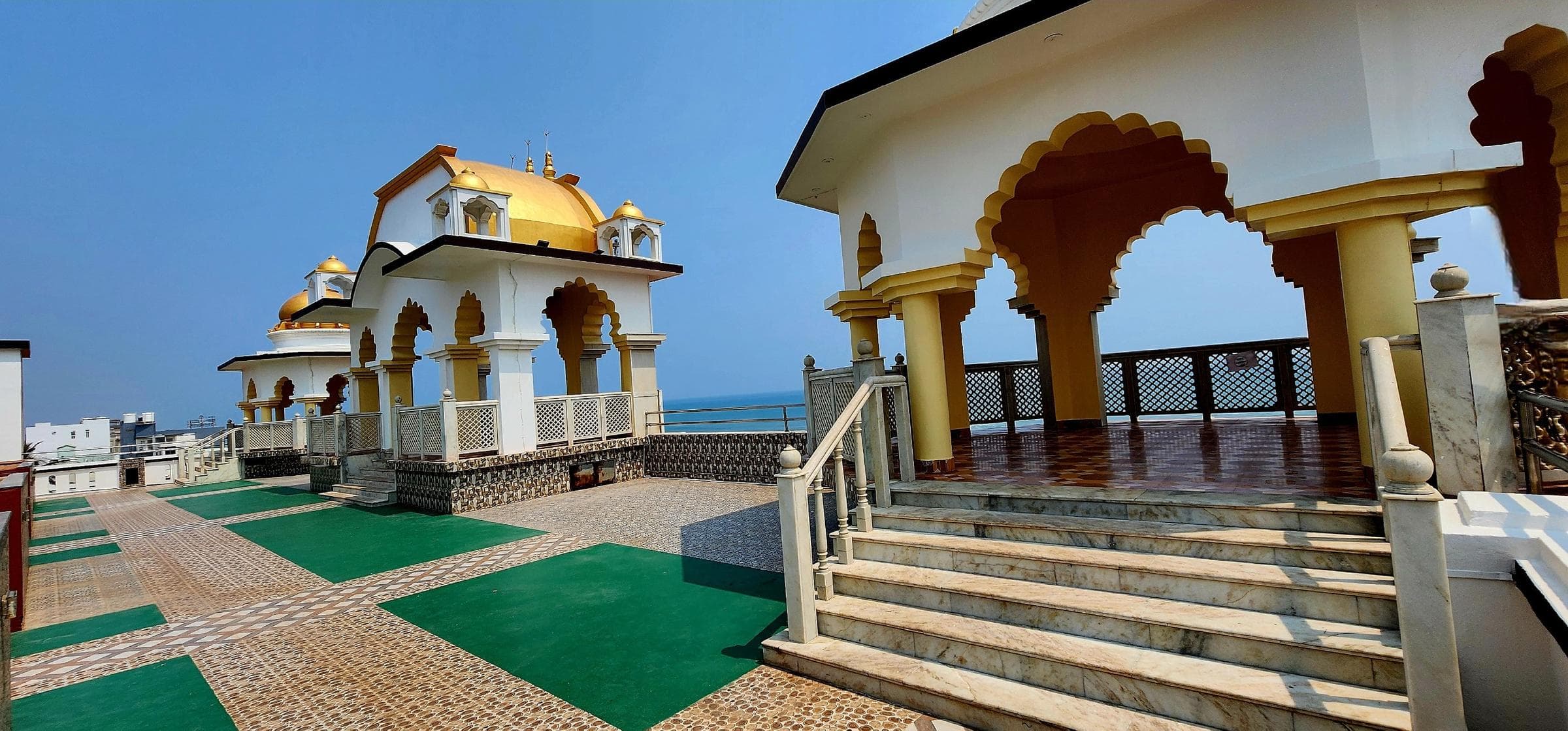Terrace with gold dome and marble chhatri pavilion overlooking Bay of Bengal